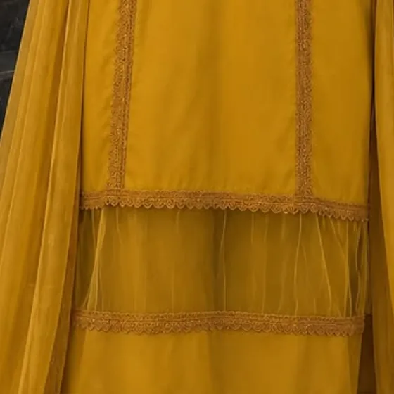 Close-up of tonal embroidered lace panels and an organza tier on mustard cotton silk