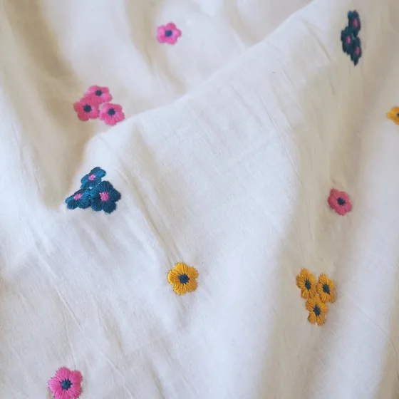 Ivory cotton scattered with small hand-embroidered flowers