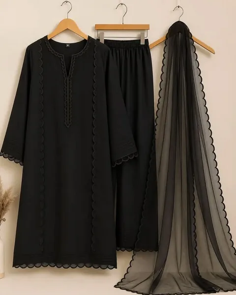 Black three-piece with tonal scalloped lace edging on the kurta, trousers and organza dupatta